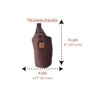 Flat layout photo of a Carhartt chocolate brown crossbody bag with measurement dashes to display scale. Made from 12 oz Carhartt duck canvas with waterproof lining and adjustable strap. Humbly and Kindly Made – Thoughtfully sewn in Northern NY.