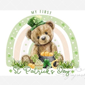May include: A teddy bear wearing a green hat with a shamrock sits in front of a rainbow. The image includes the text "My First St. Patrick's Day" and a pot of gold, a horseshoe, and a cupcake.