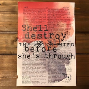 May include: A watercolor print with a red and orange background featuring a dictionary page with the text "She'll destroy us all before she's through".