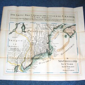 May include: An antique map of the British colonies in North America, titled "Die Gros-Britische Colonie-Lander in Nord-America." The map shows the regions of New England, New York, New Jersey, and Pennsylvania. The map is printed in black and white with hand-drawn details.