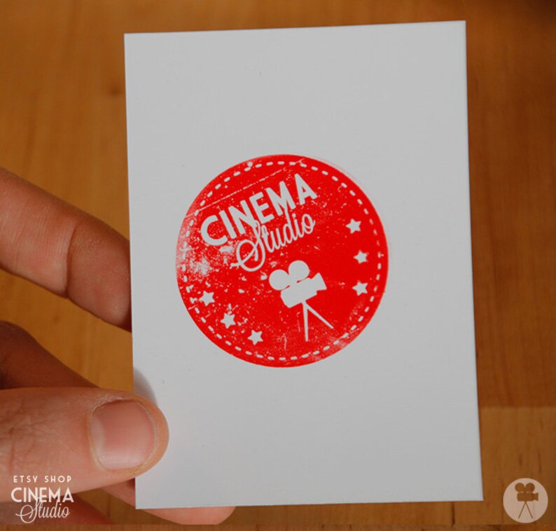 May include: A white card with a red circle containing the text "CINEMA Studio" and a white silhouette of a film camera.
