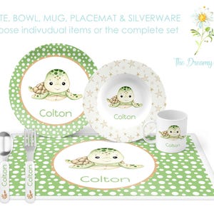 May include: A green and white placemat with a white and gold bowl, a green and white plate, a white mug, and two silver utensils. The placemat, bowl, plate, and mug all feature a cartoon sea turtle with the name "Colton" printed on them. The text "PLATE, BOWL, MUG, PLACEMAT & SILVERWARE Choose individual items or the complete set" is printed at the top of the image. The text "The Dreamy Daisy" is printed in the bottom right corner of the image.