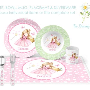May include: A pink and green children's dinnerware set with a princess design. The set includes a plate, bowl, mug, placemat, and silverware. The placemat and all items feature a princess illustration with the name "Emma".