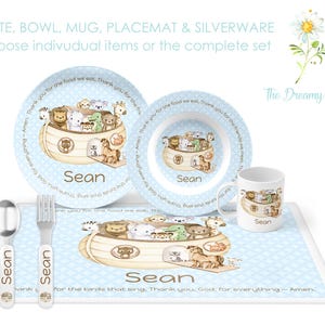 May include: A blue and white children's placemat with a Noah's Ark theme. The placemat features a brown wooden ark with animal figures, including a lion, zebra, giraffe, and elephant. The placemat also includes a matching plate, bowl, and mug with the same design. The text "Sean" is personalized on each piece. The text "Thank you, God, for everything - Amen." is printed on the placemat.