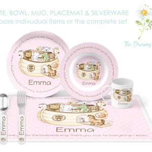 May include: Pink children's dinnerware set with a Noah's Ark theme. The set includes a plate, bowl, mug, placemat, and silverware. The placemat and dishes feature a colorful illustration of animals on a boat. The text "Thank you, God, for everything - Amen." is printed on the placemat. The name "Emma" is personalized on each piece.