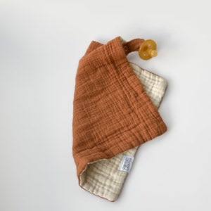 Charley Charles best selling pacifier holder blankets are a must have for new parents. Made of multiple layers of plush, fluffy crinkle gauze. This double layer muslin fabric is the perfect option for baby accessories. Soft breathable texture.