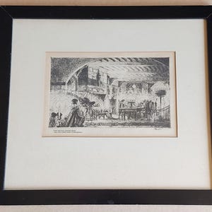 May include: A framed black and white etching depicting an interior scene with figures, featuring a black wooden frame and a cream-coloured mat. The print includes the text "THIS BATTLE IS OVER AND THE LIFE THERE WAS IT" at the bottom left corner.