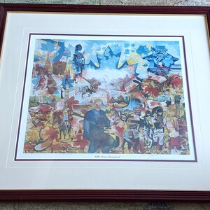 May include: A framed art print with a collage of images, including a man in a blue coat, a red car, and various figures. The print is set within a white mount and a dark brown wooden frame.