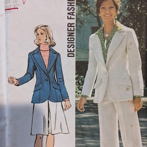 May include: A vintage sewing pattern for a white pantsuit and a blue blazer. The pattern number is 5454 and the size is 18, bust 40 inches. The pattern is from Simplicity Designer Fashion.