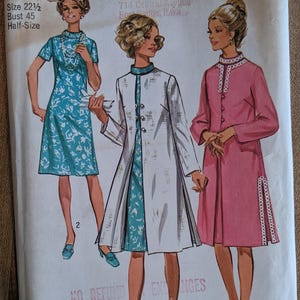 May include: Vintage Simplicity sewing pattern featuring illustrations of three dresses. The pattern includes a dress with a floral print, a white coat over a floral dress, and a pink dress with white trim. The bust size is 45 inches.