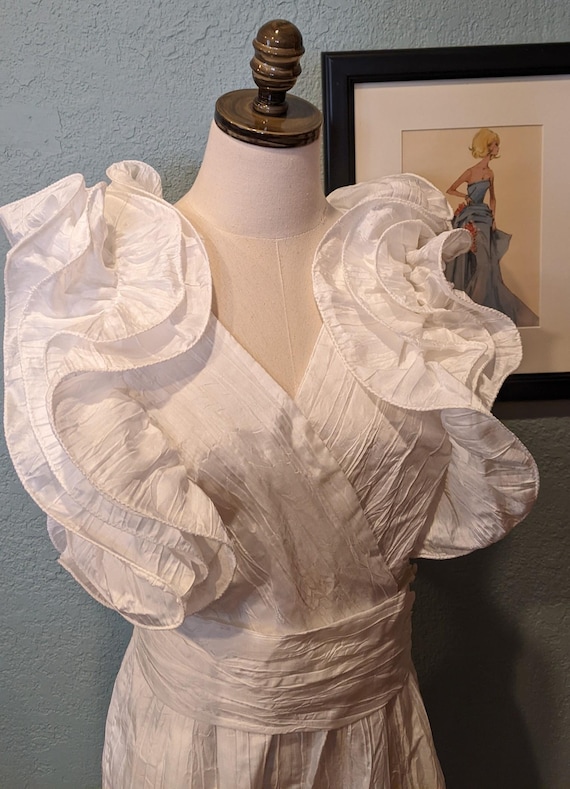 1985 Big Ruffled Shoulder Jumpsuit By B.B. Collections Size 12 White Crinkle Polyester Open back with string ties & cummerbund belt