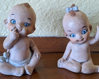 Pair of Vintage Kewpie Figurines Piano Babies, Blue eyed Boy in a diaper and Blue eyed Girl with blue hair bow