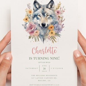 May include: A watercolour illustration of a wolf surrounded by pink, yellow, and purple flowers. The text "Charlotte is turning nine!" is written in pink script. The text "Let's go wild" is written in green. The date "Aug 26, 2024" and time "3 o'clock" are written in black. The text "The Millers Residence 327 Latigo Canyon Rd, Malibu, CA" is written in black. The text "RSVP to Kelly 01234567890 by 11.12.23" is written in black.