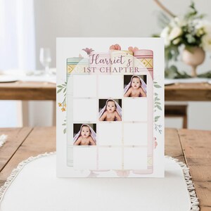 May include: A baby milestone card with the text "Harriet's 1st Chapter" in a script font. The card features a grid of squares, with three photos of a baby in a towel. Floral and book illustrations decorate the edges.
