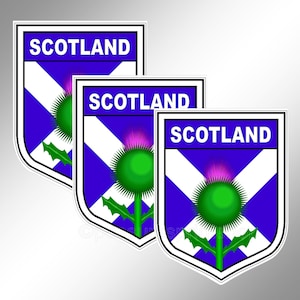 Decal or Car bumper sticker. Three small Scottish shield decals with the flag, the thistle and SCOTLAND. Approx 42 x 55 mm each