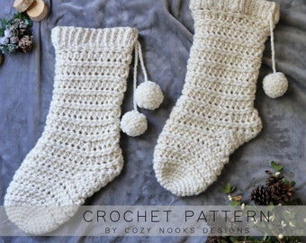 May include: Two off-white crochet stockings featuring a ribbed cuff and hanging yarn pom-poms. The text CROCHET PATTERN BY COZY NOOKS DESIGNS is printed at the bottom of the image over the stockings and gray fabric background.