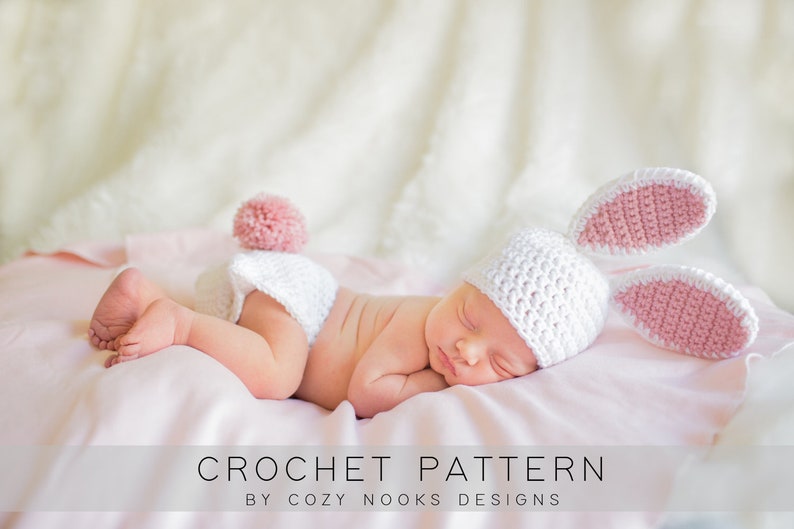 May include: A newborn baby wearing a white crochet bunny hat with pink inner ears and a matching diaper cover with a pink pom-pom tail. The baby is lying on a pink blanket. The text "CROCHET PATTERN" is visible.