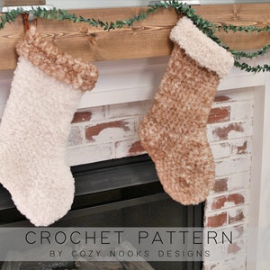 May include: Two crocheted Christmas stockings hanging on a wooden mantel above a fireplace. The stockings are made with a fluffy yarn in white and brown. The text "CROCHET PATTERN BY COZY NOOKS DESIGNS" is at the bottom of the image.