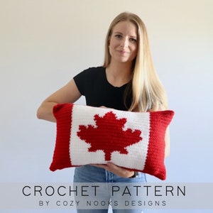 May include: A crochet pattern for a Canadian flag pillow. The pillow is red and white with a red maple leaf in the center. The pattern is by Cozy Nooks Designs.