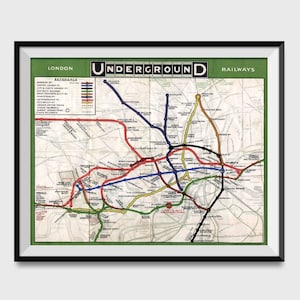 May include: A vintage London Underground map poster with a green border and the text "LONDON UNDERGROUND RAILWAYS". The map shows the different lines of the London Underground, including the Bakerloo, Central, Circle, District, Hammersmith & City, Metropolitan, Northern, Piccadilly, Victoria, and Waterloo & City lines. The map is in a black frame.