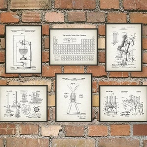 May include: A set of six vintage-style scientific patent prints. The prints are black and white and feature illustrations of various scientific equipment. The prints are framed in black frames and are hung on a brick wall.