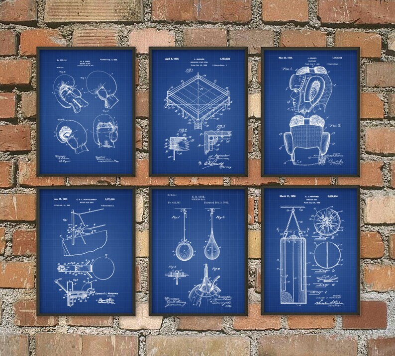 May include: Six framed blue prints of boxing equipment, including gloves, a ring, and a punching bag, are displayed against a brick wall. The blueprints are white line drawings on a blue grid background, with dates and technical details.