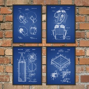 May include: Four vintage blue blueprint style prints of boxing equipment. The prints feature drawings of boxing gloves, a head guard, a punching bag, and a boxing ring. Each print includes the patent number, date, and inventor's name.