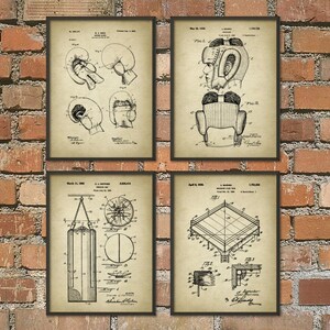 May include: Set of four vintage boxing patent prints. The prints are black and white and feature illustrations of boxing gloves, a boxing helmet, a punching bag, and a boxing ring. The prints are on a cream-colored background and have a distressed look.