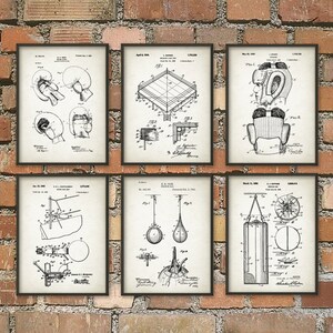 May include: Six framed vintage patent prints featuring boxing equipment, including gloves, a ring, headgear, a speed bag, and a punching bag. The prints are in black and white, with detailed technical drawings on a cream-colored background.