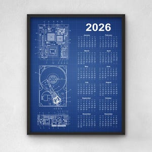 May include: Framed 2026 calendar with a blueprint design. The calendar features a blue background with white technical drawings of computer components. The year 2026 is displayed at the top, with the months and dates arranged below.