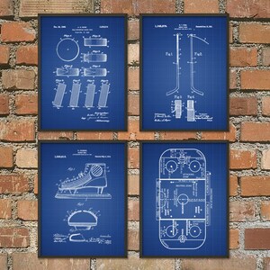 May include: Set of four blue and white vintage hockey patent prints. The prints feature illustrations of hockey equipment, including a puck, a stick, a skate, and a hockey rink.