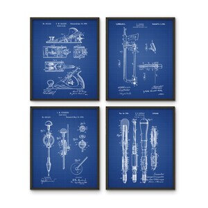 May include: Set of four vintage blueprint style prints featuring woodworking tools. The prints are framed in black and have a blue background. The prints feature a plane, a saw, a drill, and a screwdriver.
