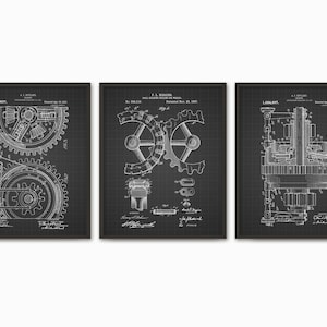 May include: Set of three black and white vintage patent prints featuring illustrations of gears and machinery. The prints are framed in black frames and have a grid pattern background.