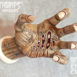 Left ZOMBIE DEATHGRIPS™ Wall Hanger for guitars and other items. By Artist Gabe Escamilla