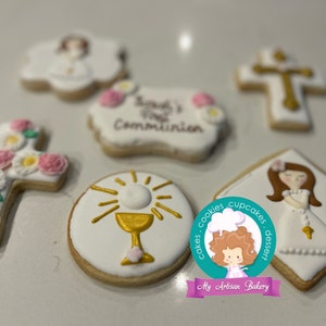 May include: A set of six decorated sugar cookies featuring a cross with flowers, a chalice, a girl in a white dress, and the text "Sarah's First Communion".