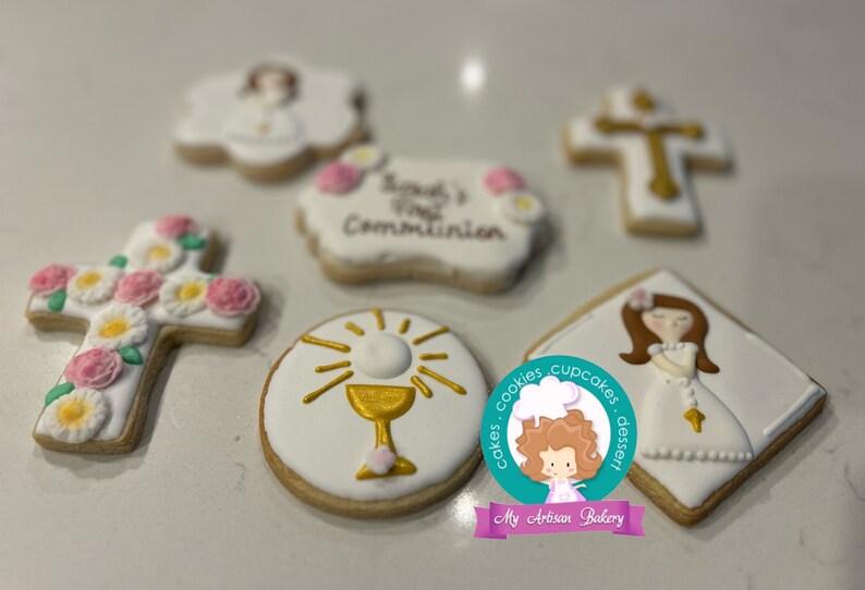 May include: A set of six decorated sugar cookies featuring a cross with flowers, a chalice, a girl in a white dress, and the text "Sarah's First Communion".