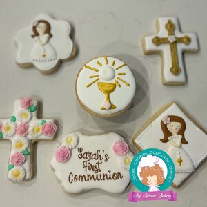 May include: Set of six decorated sugar cookies for a First Communion celebration. The cookies feature a cross with pink flowers, a chalice with a host, a girl in a white dress, and a banner that reads "Sarah's First Communion".