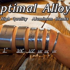 May include: A selection of aluminum cuff bracelets in various widths, from 1 inch to 1/8 inch, are displayed on a wrist. The bracelets are engraved with "Optimal Alloys". The image also includes the text "High Quality Aluminum blanks".