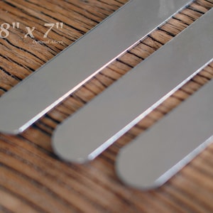 May include: Three silver metal strips, each 3/8 inch by 7 inches, laid out on a wooden surface.  3/8" x 7" Optional Alloys