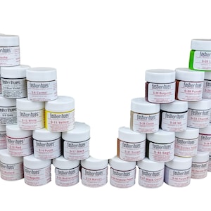May include: A collection of 40 small jars of leather dye in various colors, arranged in a semi-circle. The jars are labeled with the brand name "fashenhues" and a color code.