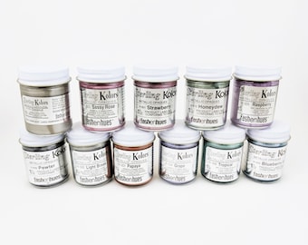May include: Ten small jars of metallic opaque paint in various colors, including coconut, sassy rose, strawberry, honeydew, raspberry, pewter, light brass, papaya, grape, tropical, and blueberry. Each jar is labeled with the color name and "Sterling Kolors" with the tagline "fashenhues".