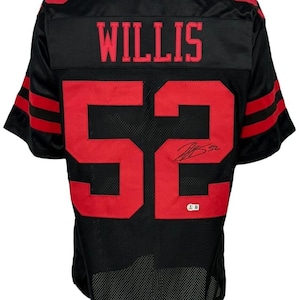 May include: Black football jersey with red accents. The jersey features the name "WILLIS" across the shoulders and the number "52" on the back. Red stripes adorn the sleeves. A signature is visible below the number.