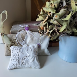 Pretty Lavender Sachets, set of three, made from a collection of delicate lace trim, embroidered fabric, finely woven linen fabric, button