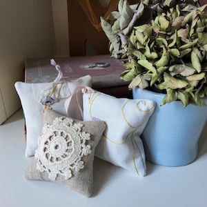 Pretty Lavender Sachets, set of three, made from a collection of delicate lace trim, embroidered fabric, finely woven fabric, beads, buttons
