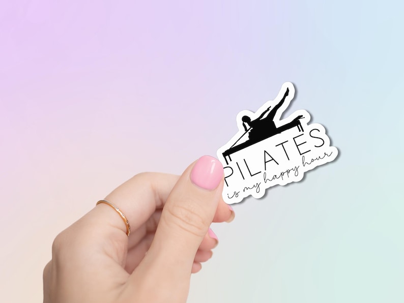 May include: A black and white sticker with a silhouette of a person doing pilates on a reformer. The text on the sticker reads "Pilates is my happy hour."