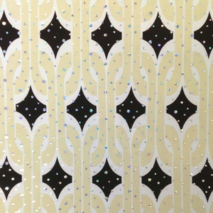 May include: A white background with a repeating pattern of black diamond shapes. The diamonds are outlined in white and have a white chain-like pattern running vertically through them. The background is covered in small, iridescent glitter.