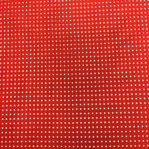 May include: Red fabric with a white grid pattern. The fabric has a textured surface.