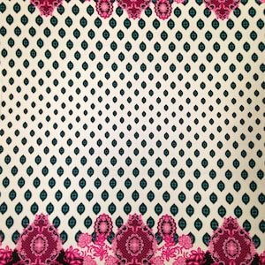 May include: White fabric with a repeating pattern of teal diamonds. The fabric has a pink and black floral border with intricate designs.