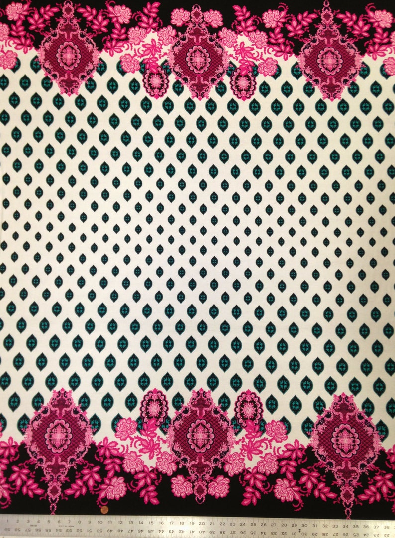 May include: White fabric with a repeating pattern of teal diamonds. The fabric has a pink and black floral border with intricate designs.