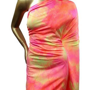 May include: Pink, yellow, and orange tie-dye fabric with a glittery finish. The fabric is draped over a mannequin.